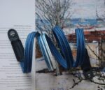 Close up of HOZUMA Blue Mt. Fuji Kumihimo silk camera strap showing braided texture, attached to a black Leica M11 camera.